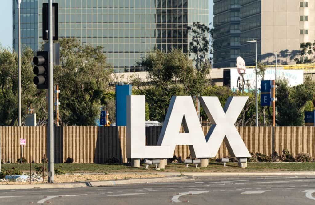The famous LAX sign at Los Angeles International Airport on a sunny day.